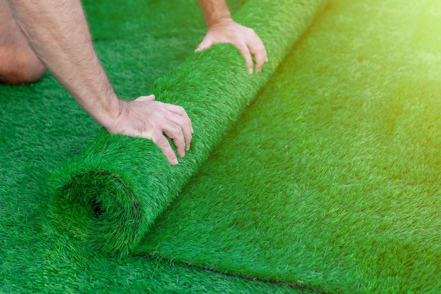 Man Rolling Artificial Grass